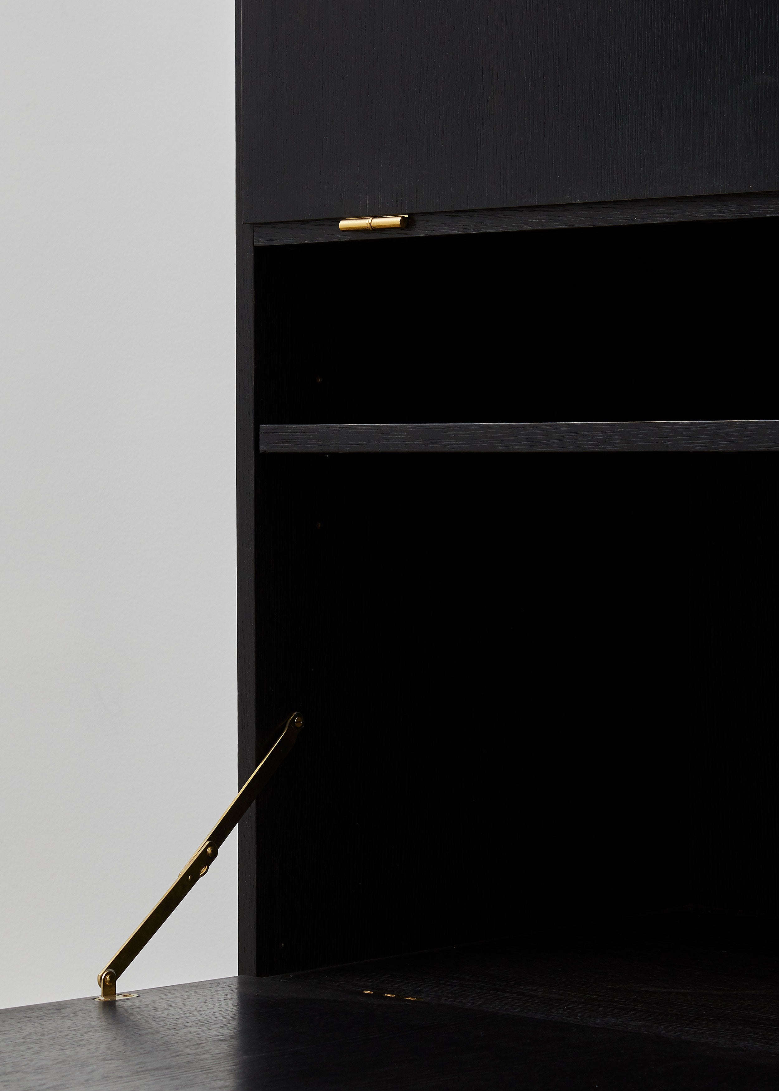 PH Cabinet by Poul Henningsen, Danish design classic (1930s)
A black wooden storage cabinet with three concealed compartments and gold-colored accents.