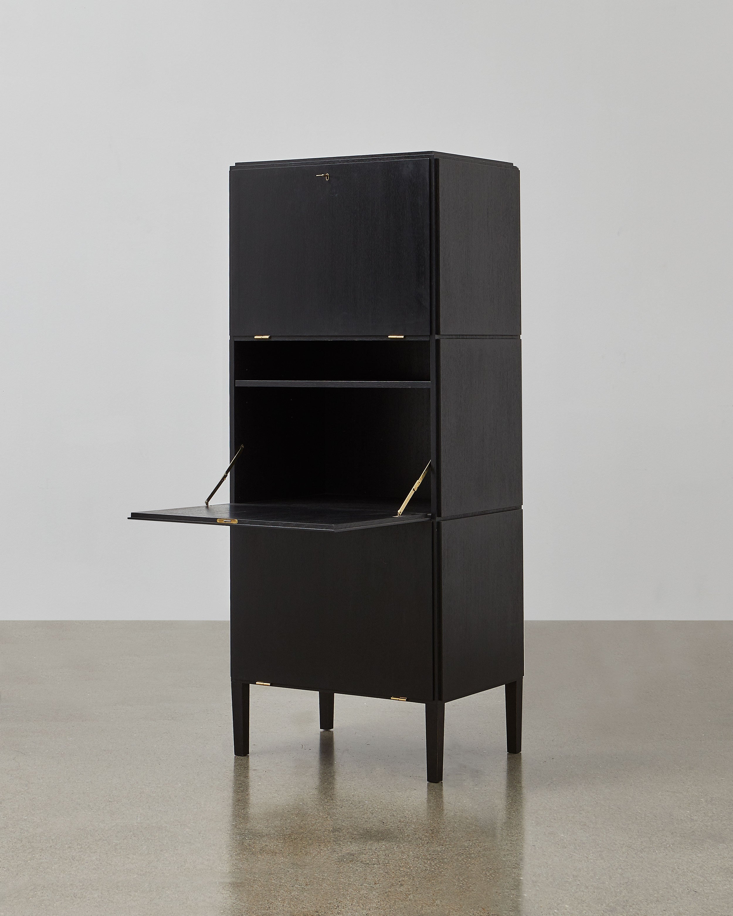 PH Cabinet by Poul Henningsen, Danish design classic (1930s)
A black wooden storage cabinet with three concealed compartments and gold-colored accents.