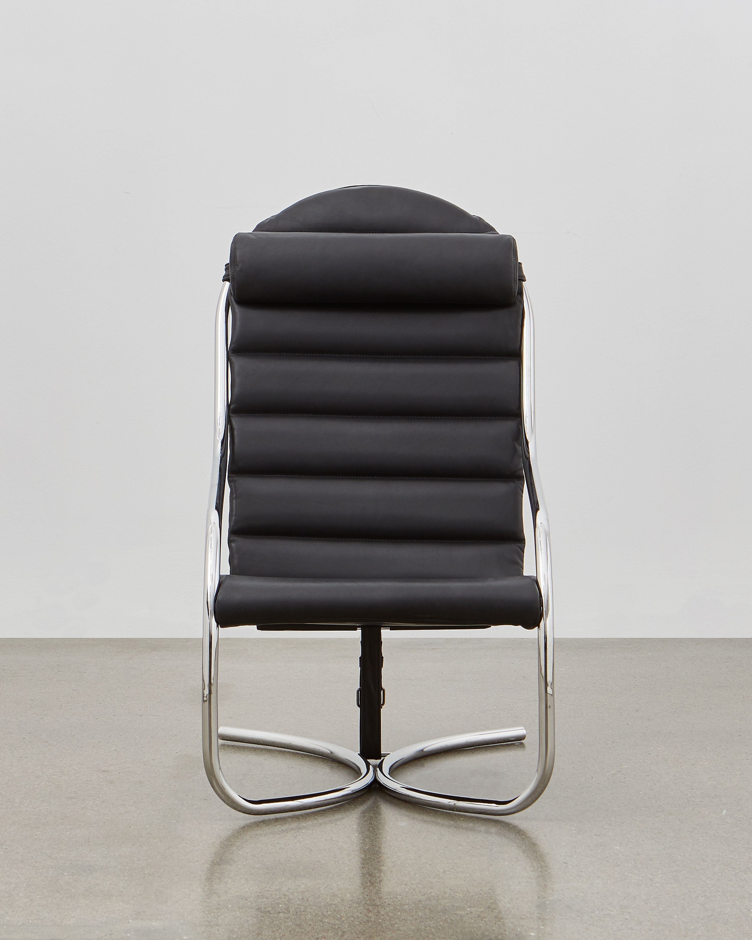 A black upholstered PH lounge chair with a chromed steel tube frame, designed by Poul Henningsen.
