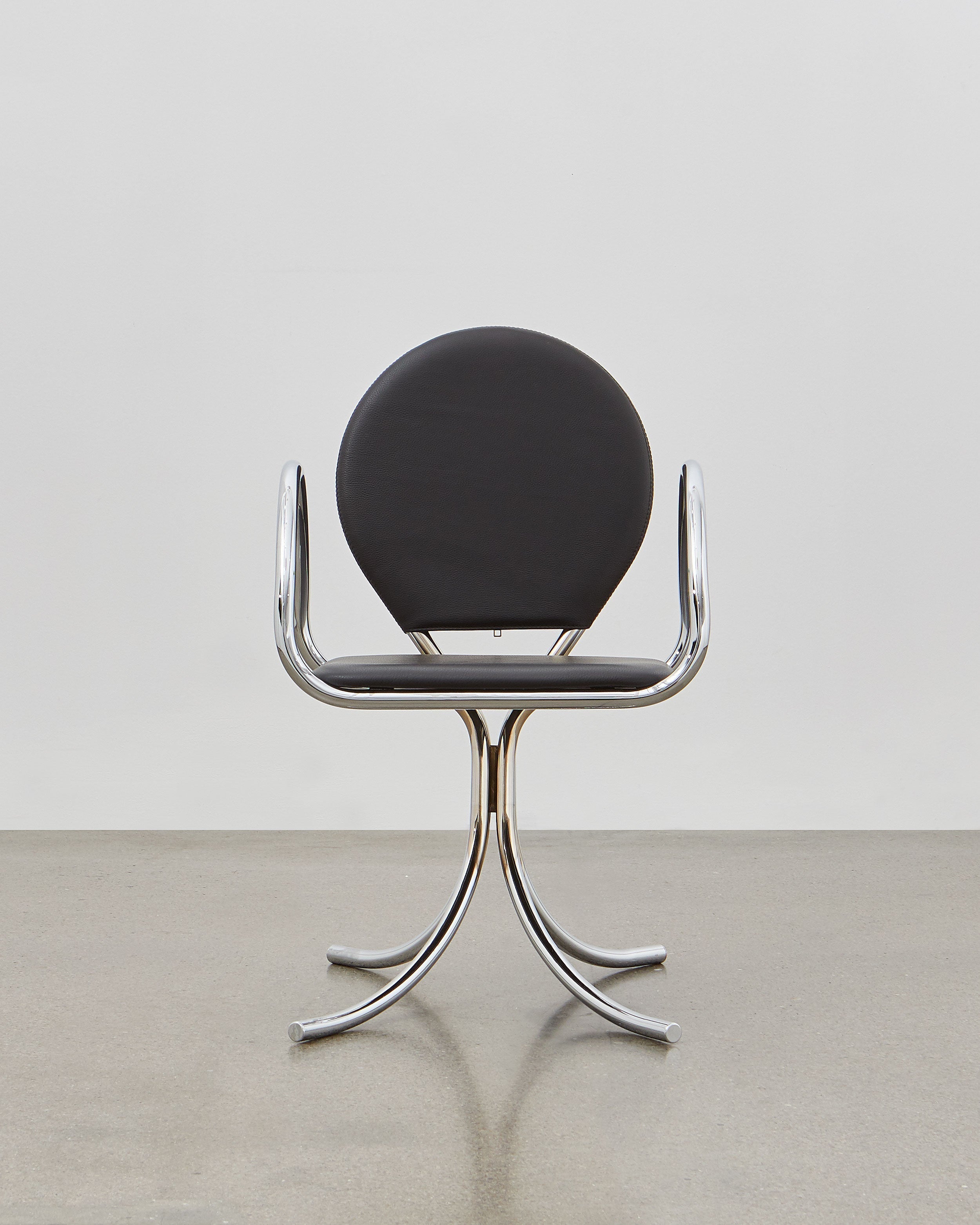 PH Arm Chair by Poul Henningsen, Danish design classic (1932),A armchair with a black cushioned seat and backrest, and chrome steel tube frame.