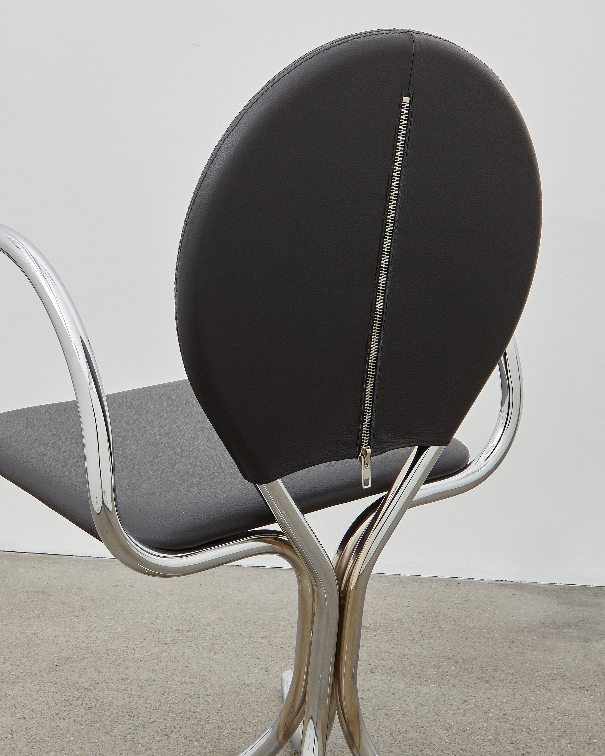 PH Arm Chair by Poul Henningsen, Danish design classic (1932),A armchair with a black cushioned seat and backrest, and chrome steel tube frame.