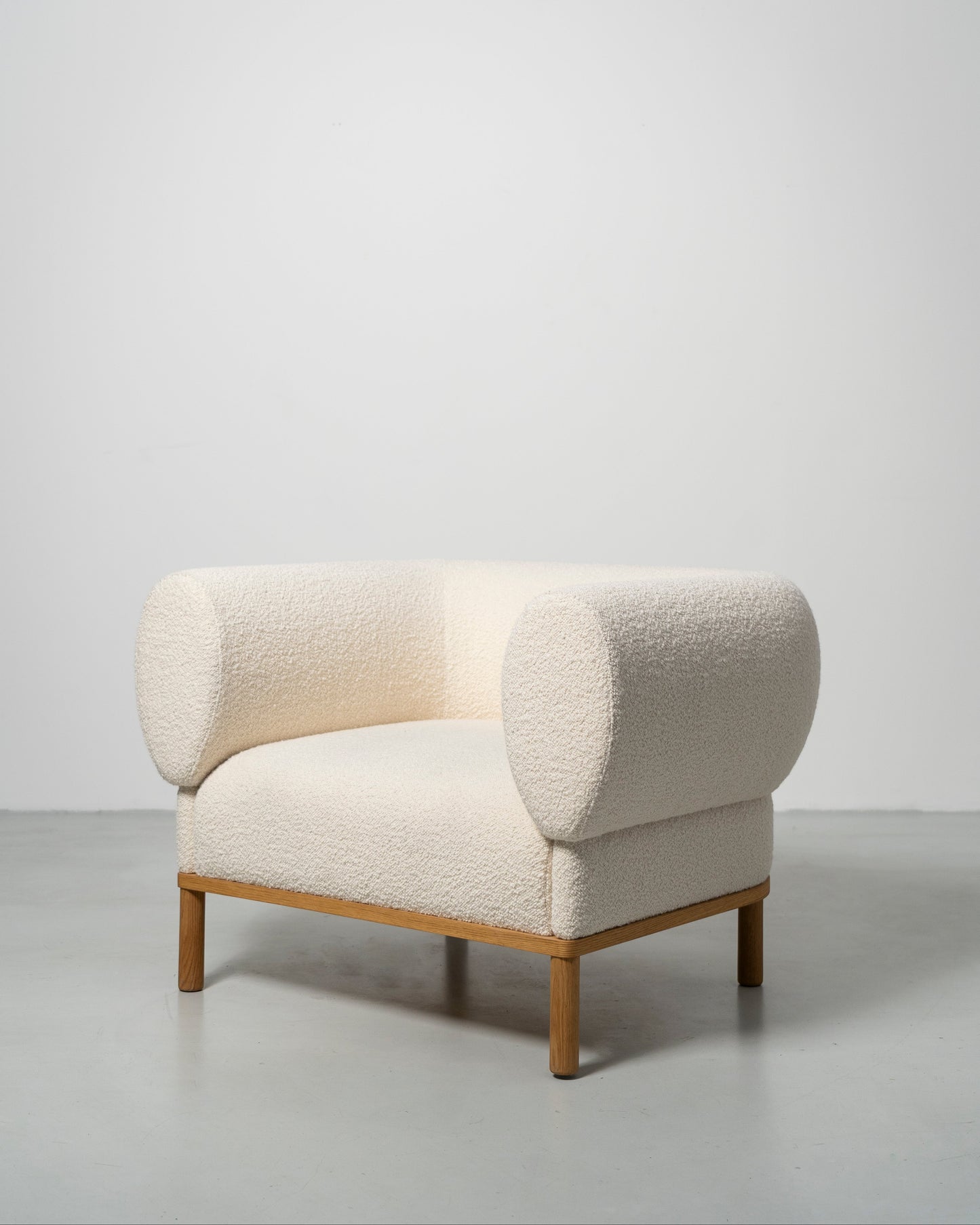 Gallant Chair by Morten & Jonas, contemporary Scandinavian design
white boucle armchair with wooden oak legs 