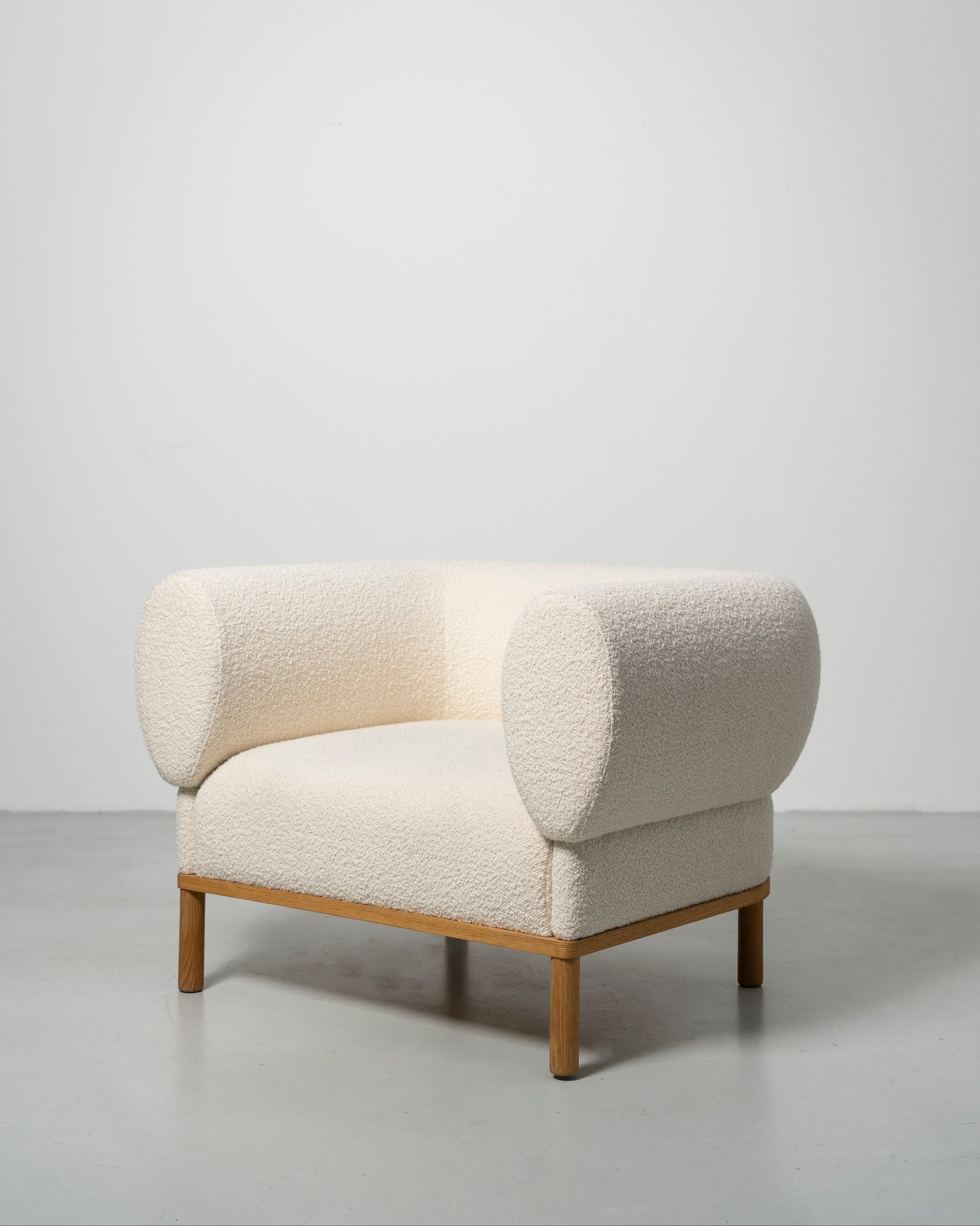 Gallant Chair by Morten & Jonas, contemporary Scandinavian design
white boucle armchair with wooden oak legs 