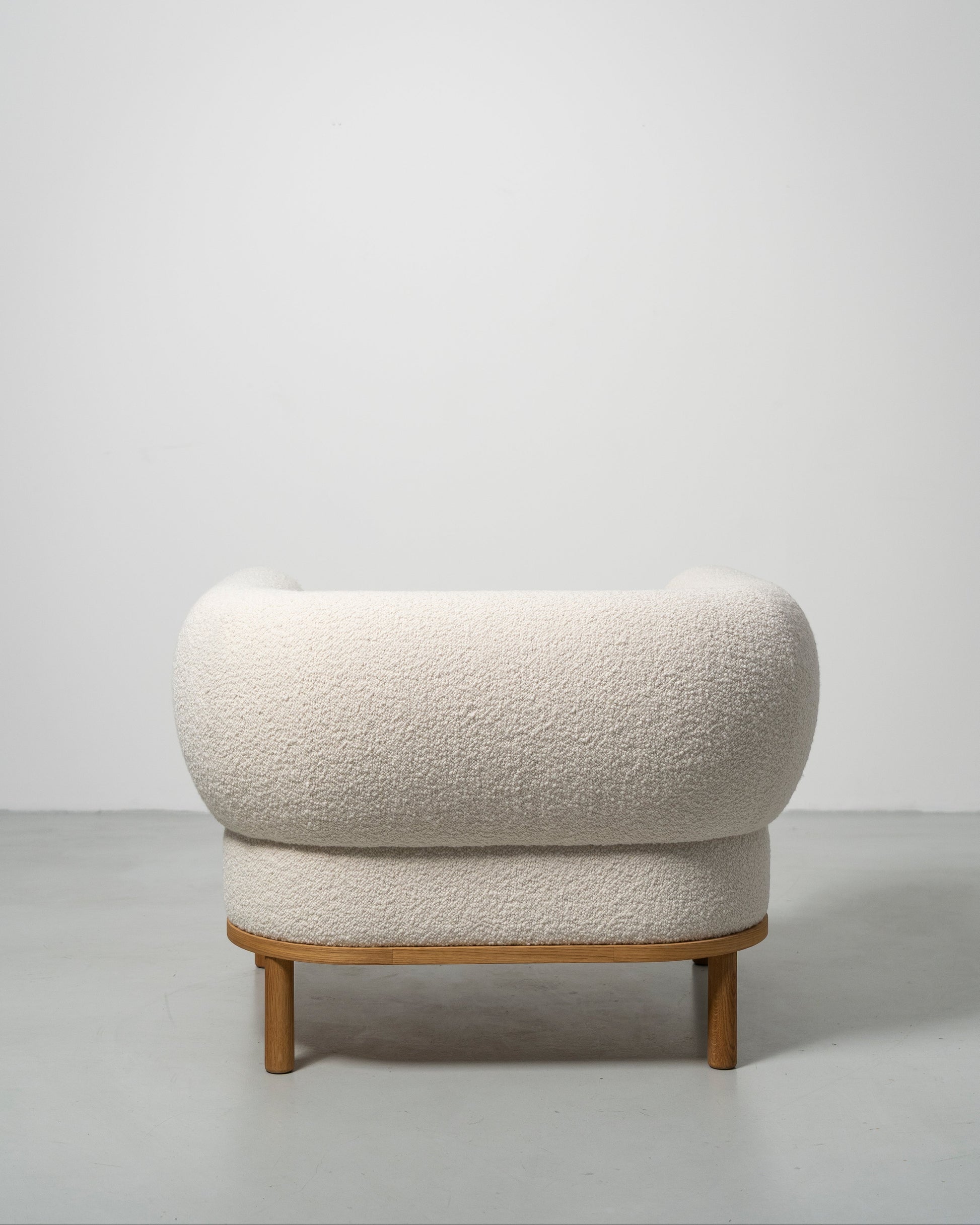 Gallant Chair by Morten & Jonas, contemporary Scandinavian design
white boucle armchair with wooden oak legs 