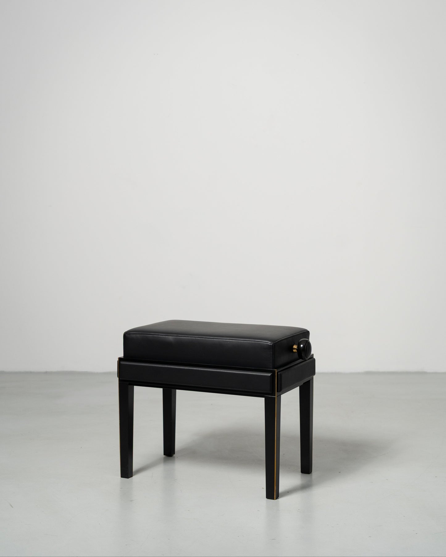 Piano Bench scandinavian design black leather seat with height adjustment leather panels on the side and wood legs with metal inset 
