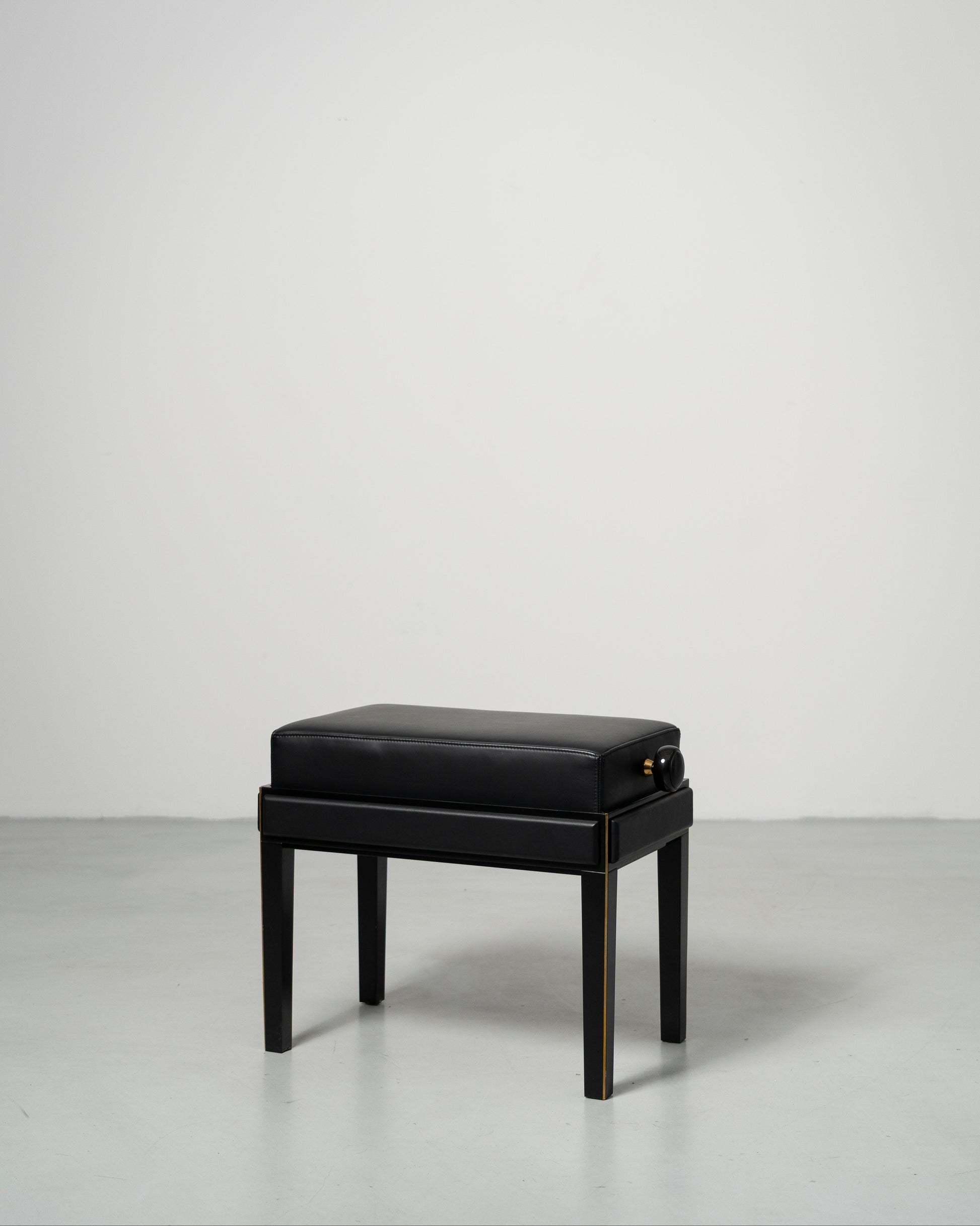 Piano Bench scandinavian design black leather seat with height adjustment leather panels on the side and wood legs with metal inset 
