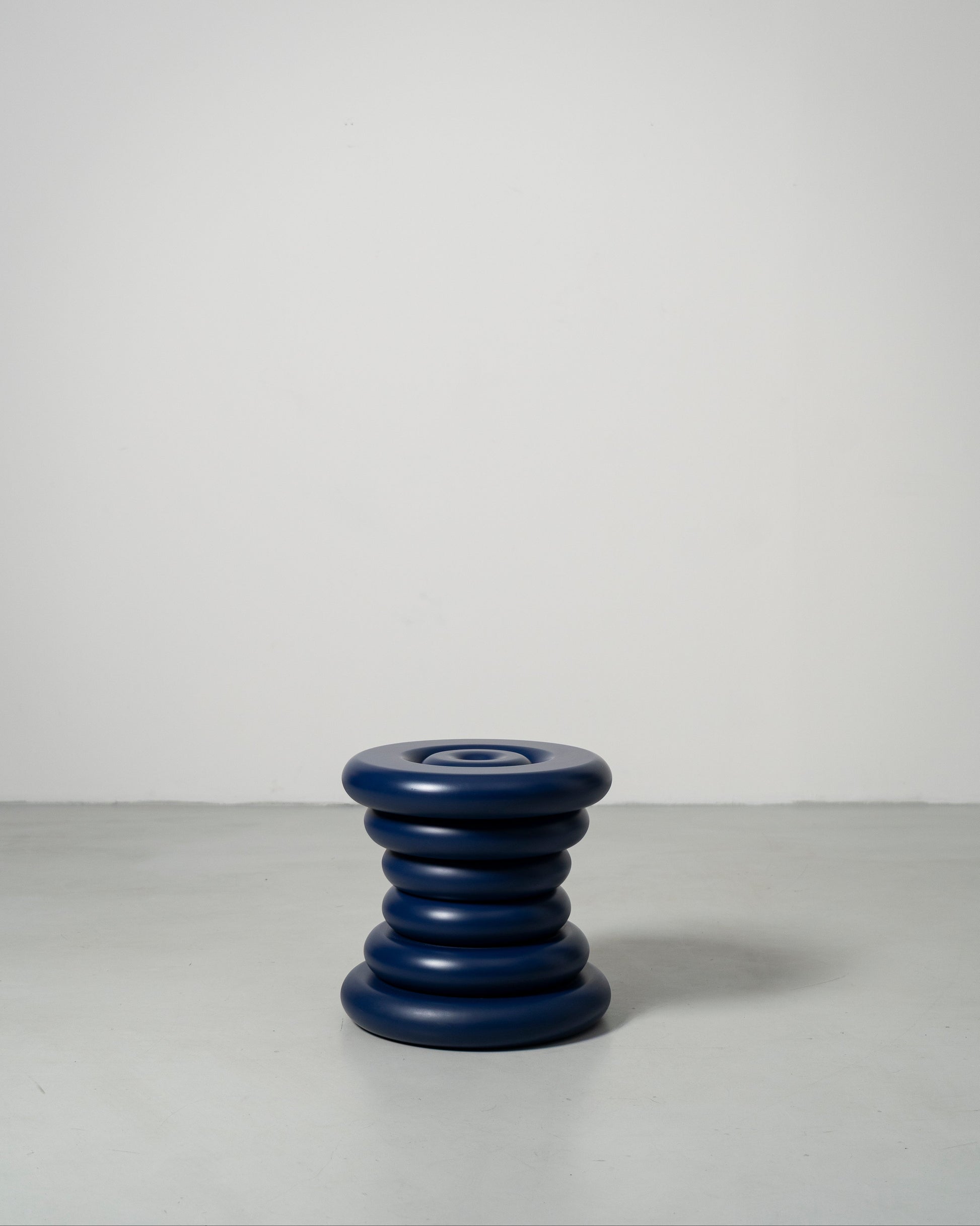 Spine Stool designed by Caisa Leifsdotter sculptural blue painted solid oak stool that also works as a compact side table