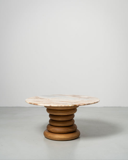 Spine Coffee Table pairs an architectural base of stacked solid-wood rings with a polished stone top, Wooden table with marble top 
