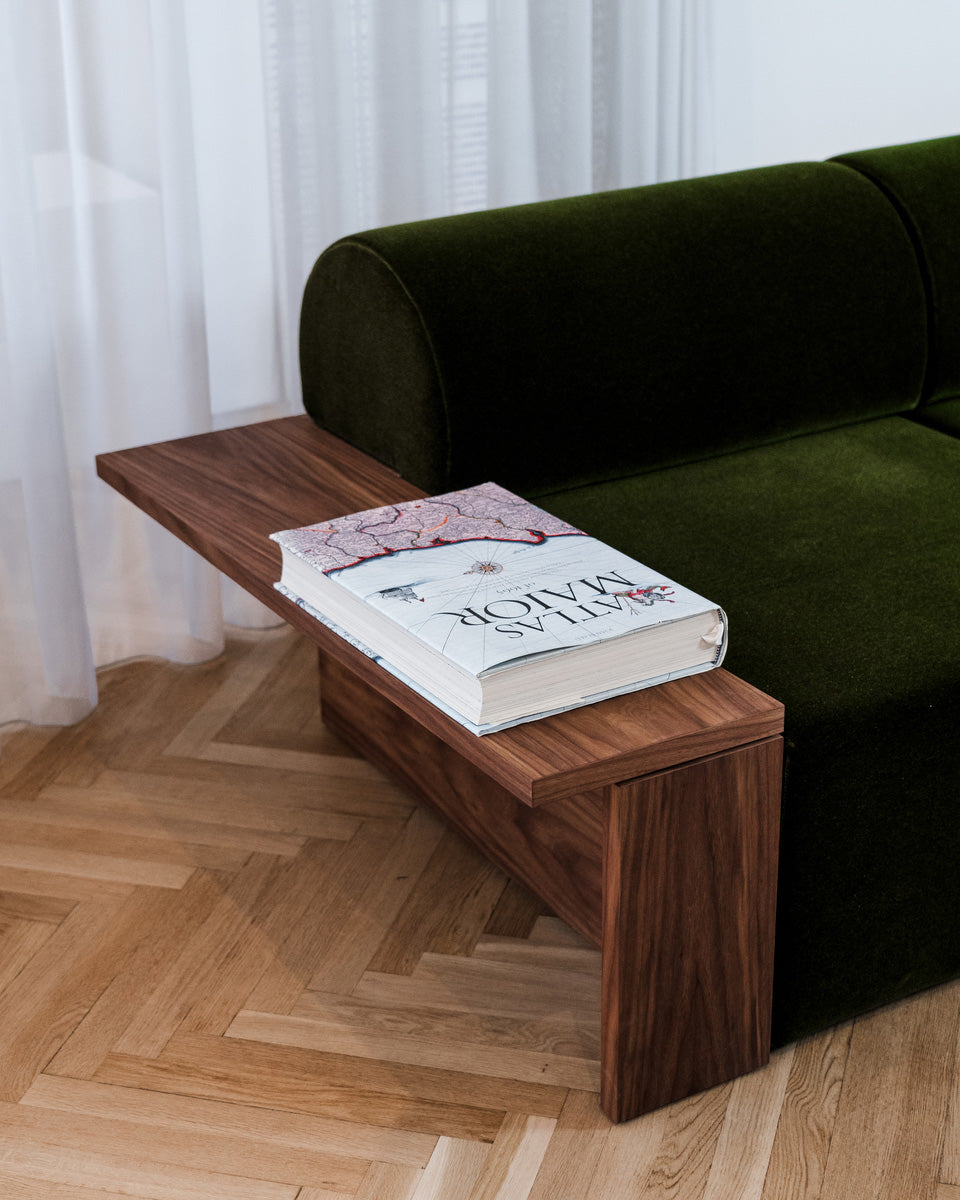 Wittorin Sofa Designed by Caisa Leifsdotter, Scandinavian design A solid-wood base frames a generous seat; movable arm and back cushions support both corner and straight layouts. The wooden surround doubles as a low table surface for lamps, books or a tray.