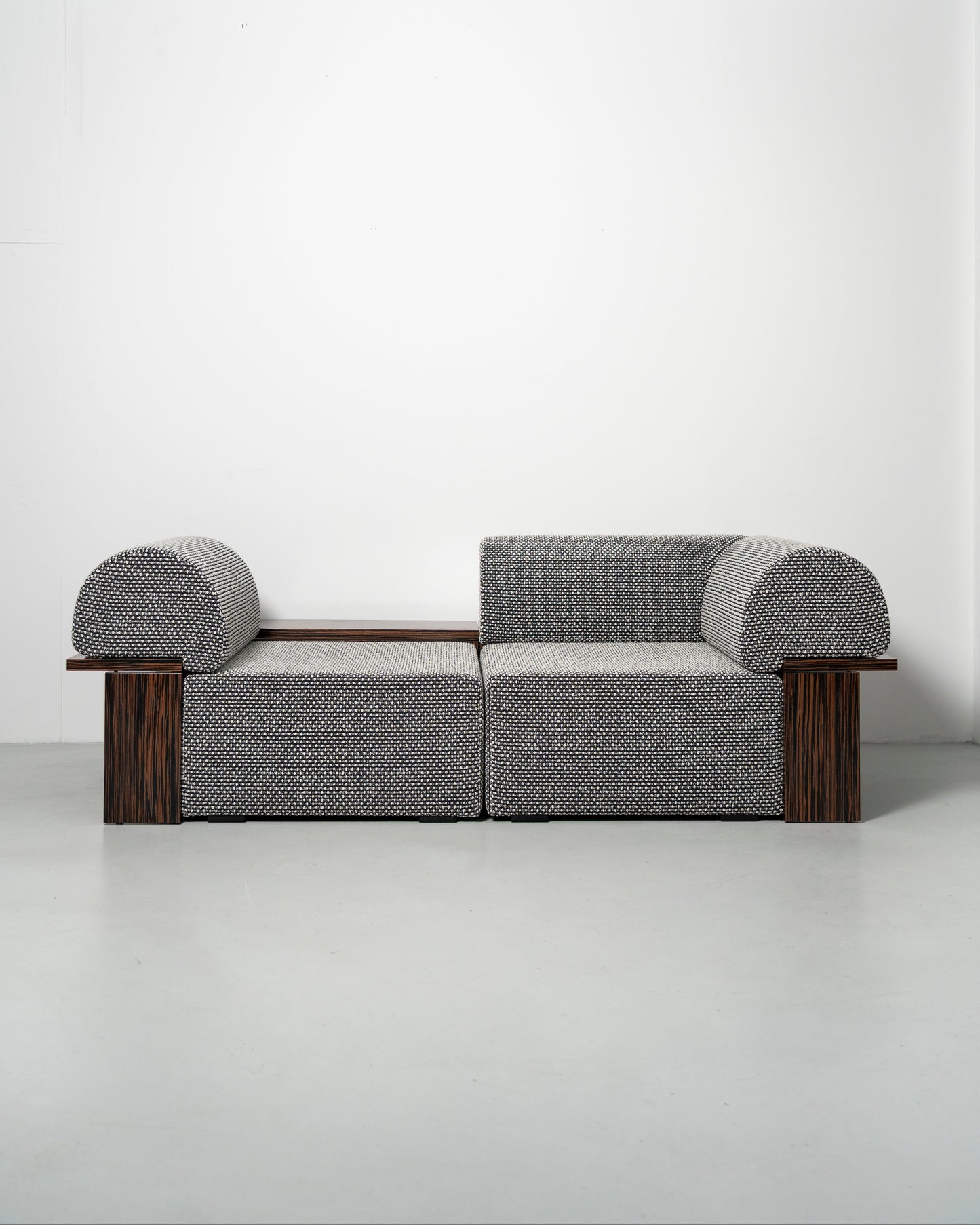 Wittorin Sofa Designed by Caisa Leifsdotter, Scandinavian design A solid-wood base frames a generous seat; movable arm and back cushions support both corner and straight layouts. The wooden surround doubles as a low table surface for lamps, books or a tray.
