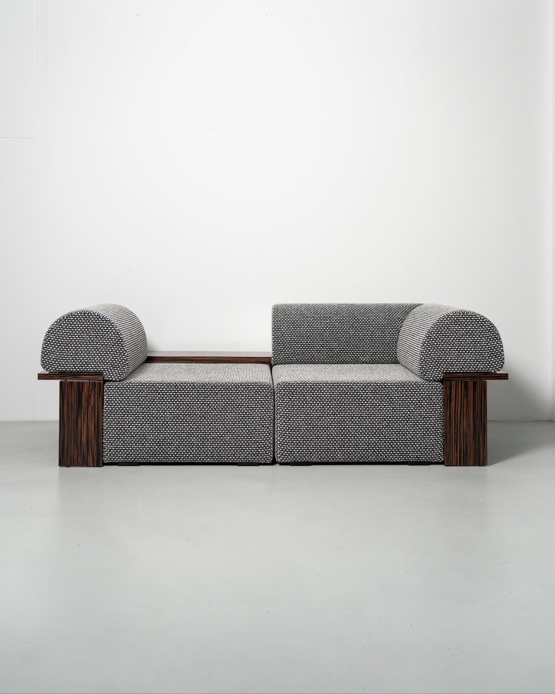 Wittorin Sofa Designed by Caisa Leifsdotter, Scandinavian design A solid-wood base frames a generous seat; movable arm and back cushions support both corner and straight layouts. The wooden surround doubles as a low table surface for lamps, books or a tray.
