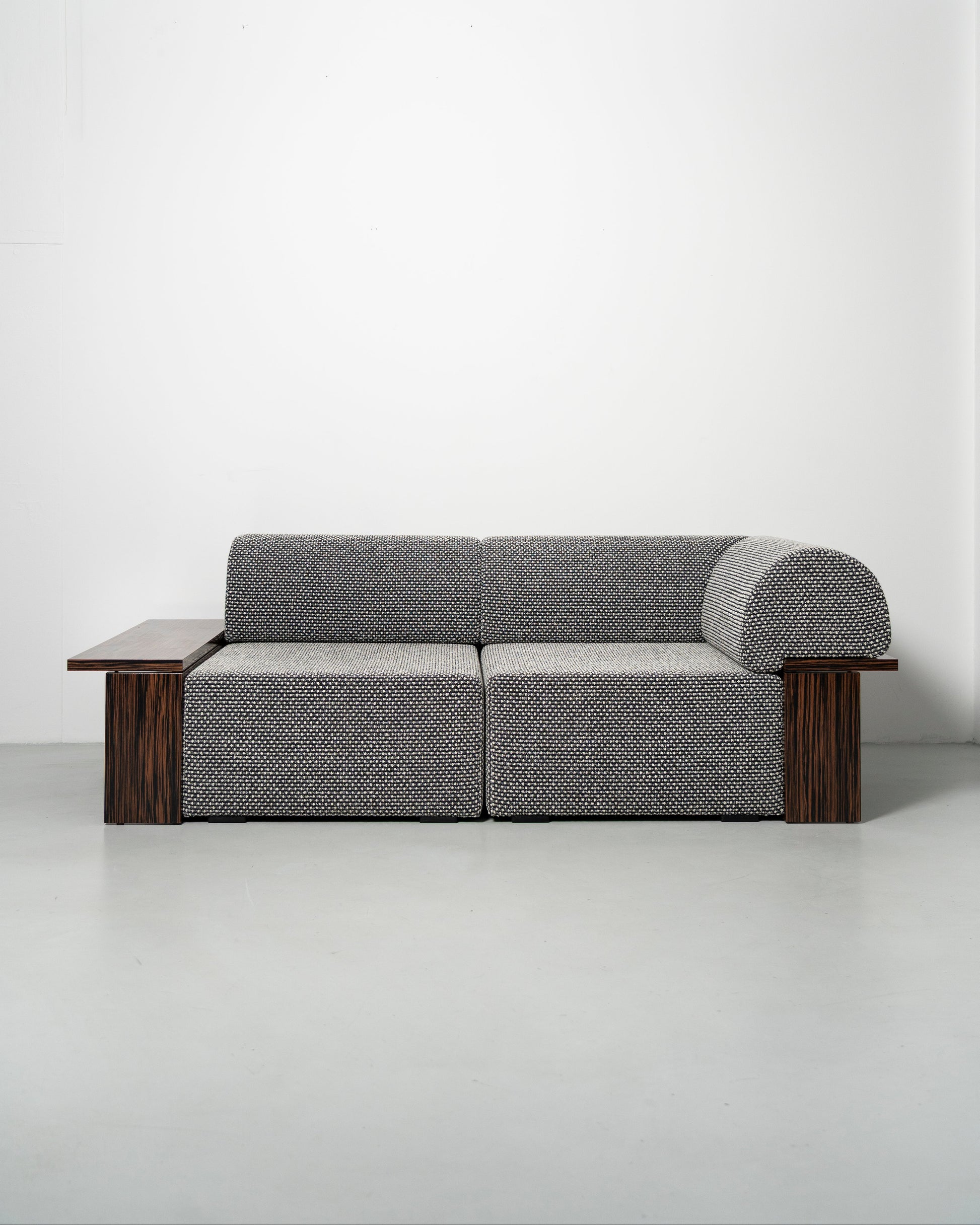 Wittorin Sofa Designed by Caisa Leifsdotter, Scandinavian design A solid-wood base frames a generous seat; movable arm and back cushions support both corner and straight layouts. The wooden surround doubles as a low table surface for lamps, books or a tray.
