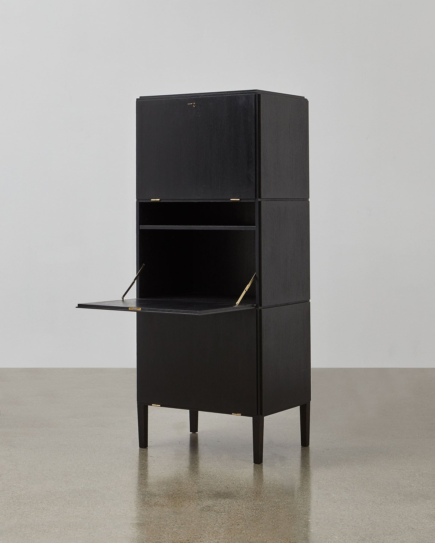 PH Cabinet by Poul Henningsen, Danish design classic (1930s)
A black wooden storage cabinet with three concealed compartments and gold-colored accents.