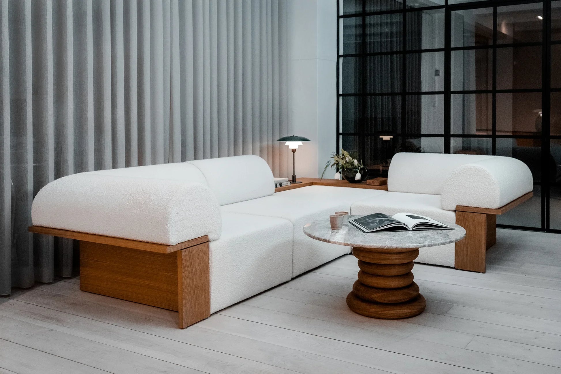 Wittorin Sofa Designed by Caisa Leifsdotter, Scandinavian design A solid-wood base frames a generous seat; movable arm and back cushions support both corner and straight layouts. The wooden surround doubles as a low table surface for lamps, books or a tray.